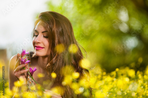 Beautiful young girl among yellow flowers © smoxx