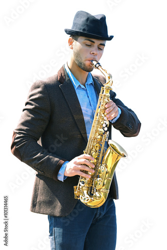 Young man playing on saxophone on the riverside