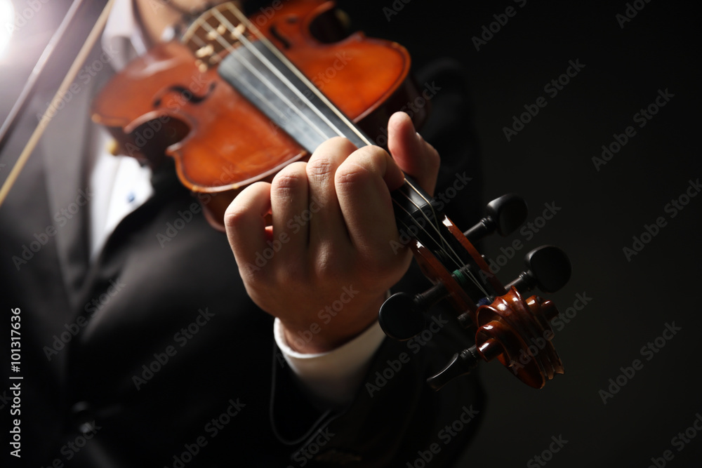 Musician play violin on black background, close up Musician play violin on black background, close up