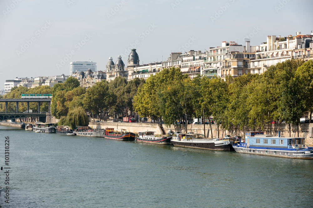 Famous quay of Seine in Paris with barges in Summer day. Paris, France