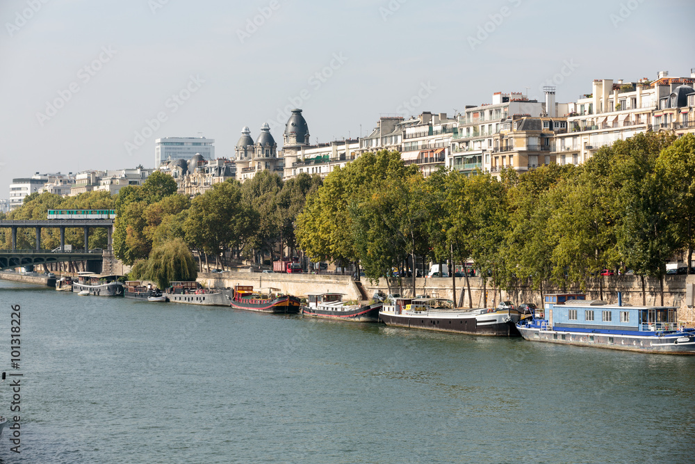 Famous quay of Seine in Paris with barges in Summer day. Paris, France Famous quay of Seine in Paris with barges in Summer day. Paris, France