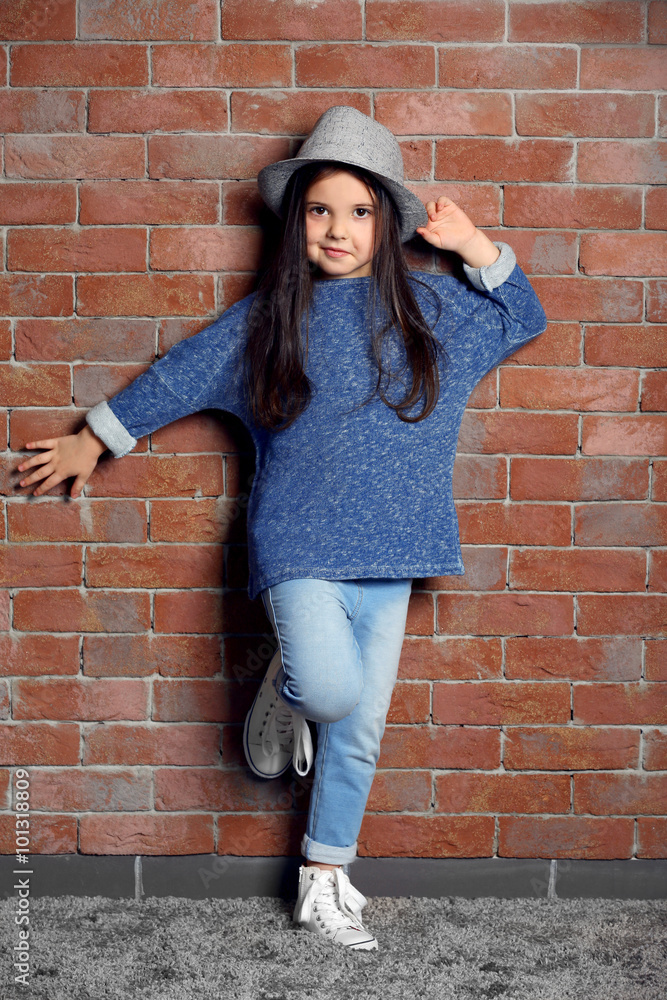 Portrait of little fashion kid girl on bricks wall background Portrait of little fashion kid girl on bricks wall background