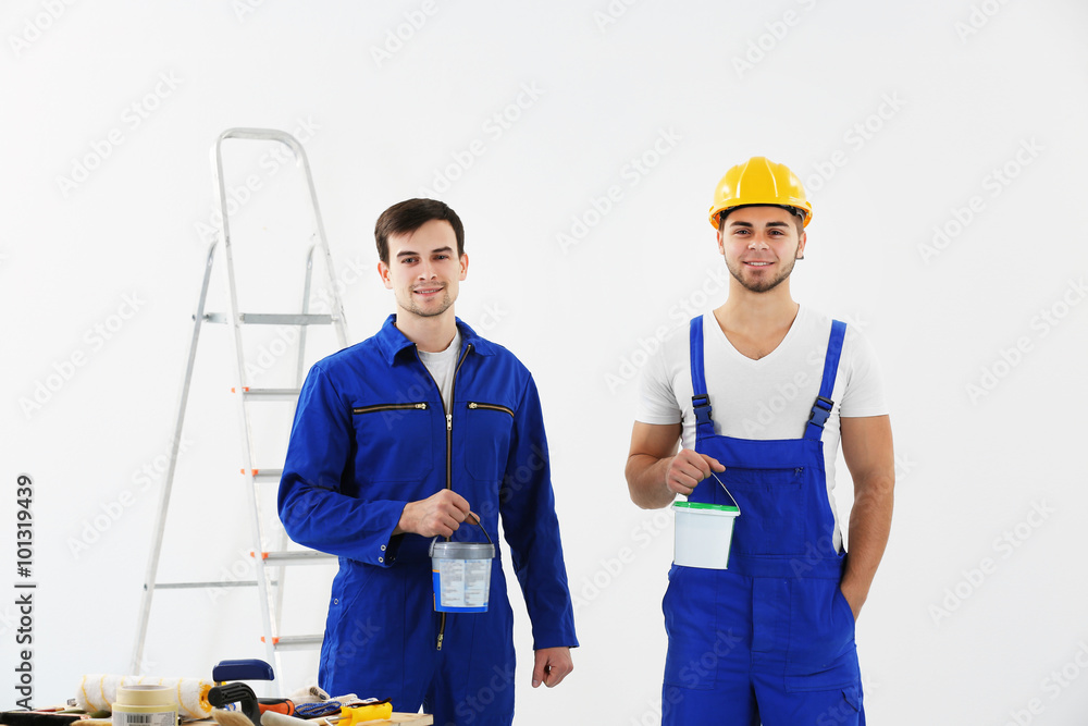 Workers renewing apartment on wall background Workers renewing apartment on wall background