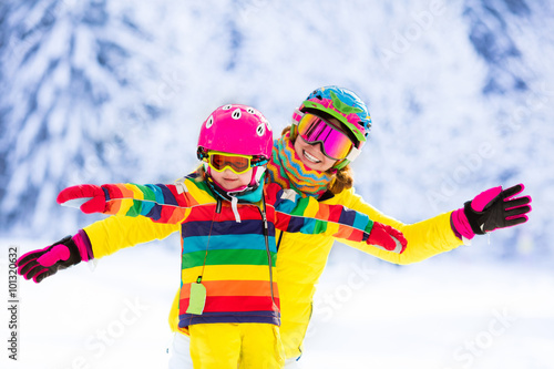 Mother and little girl learning to ski