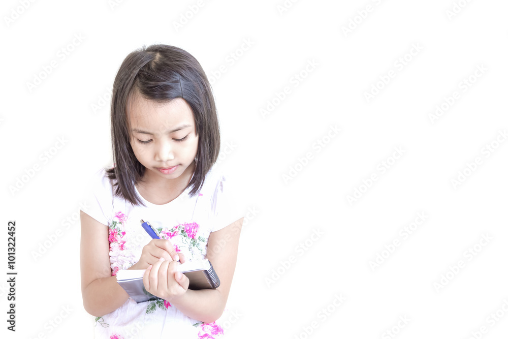 Beautiful little asian kids girl writing something on the book on white background Beautiful little asian kids girl writing something on the book on white background