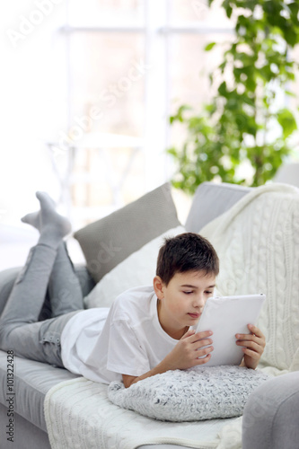 Little boy using tablet on ...