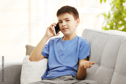 Boy using his mobile phone ...