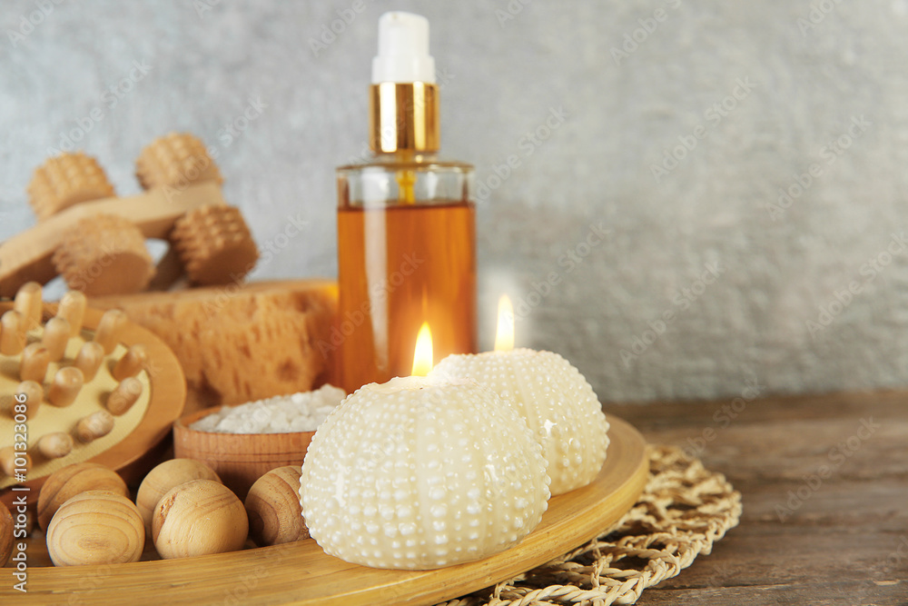 Variety of natural bath tools on wooden table, on grey wall background Variety of natural bath tools on wooden table, on grey wall background