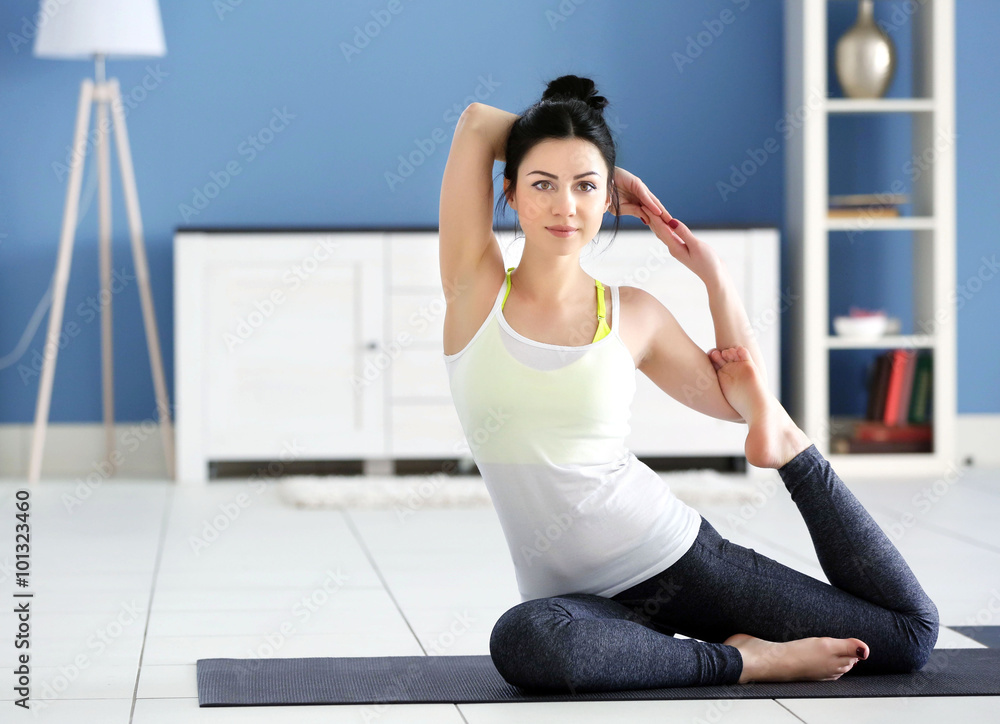 Health concept. Young attractive woman does yoga exercise in the room Health concept. Young attractive woman does yoga exercise in the room