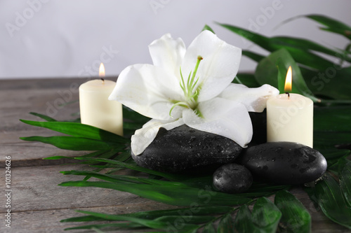 Spa still life with beautiful flower and candlelight on wooden table closeup