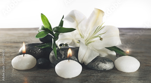Spa still life with beautiful flower and candlelight on wooden table, closeup