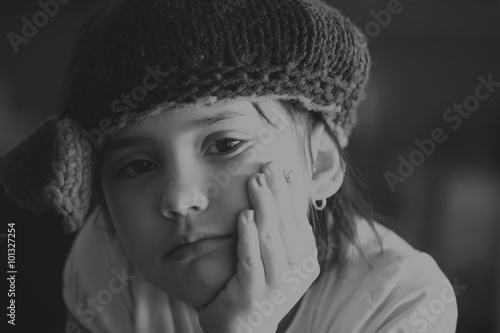 Portrait of beauty school aged brunette kid girl with black eyes indoor in black and white edition