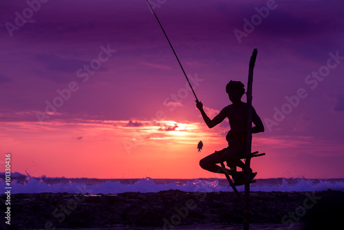Silhouette of stilt fisherman at sunset in Koggala, Sri Lanka