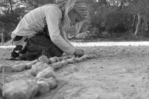 girl playing with stones photo