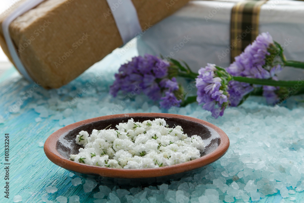 sea salt on a blue wooden table, with flowers sea salt on a blue wooden table, with flowers