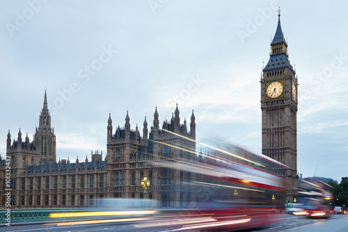 Big Ben and Palace of Westminster in the early morning  red buses passing in London