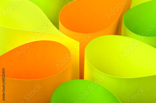 Background made of orange,yellow and green curved paper shapes photo