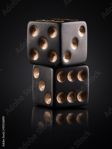 two black dice on a black background