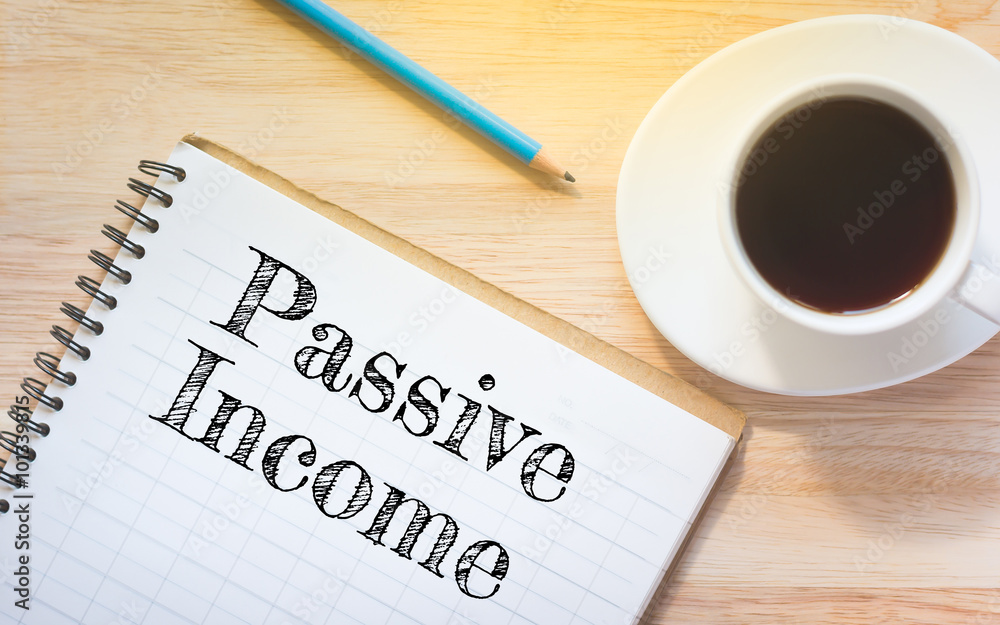 Concept Passive Income message on book. A pencil and a glass coffee table.Vintage tone. Concept Passive Income message on book. A pencil and a glass coffee table.Vintage tone.
