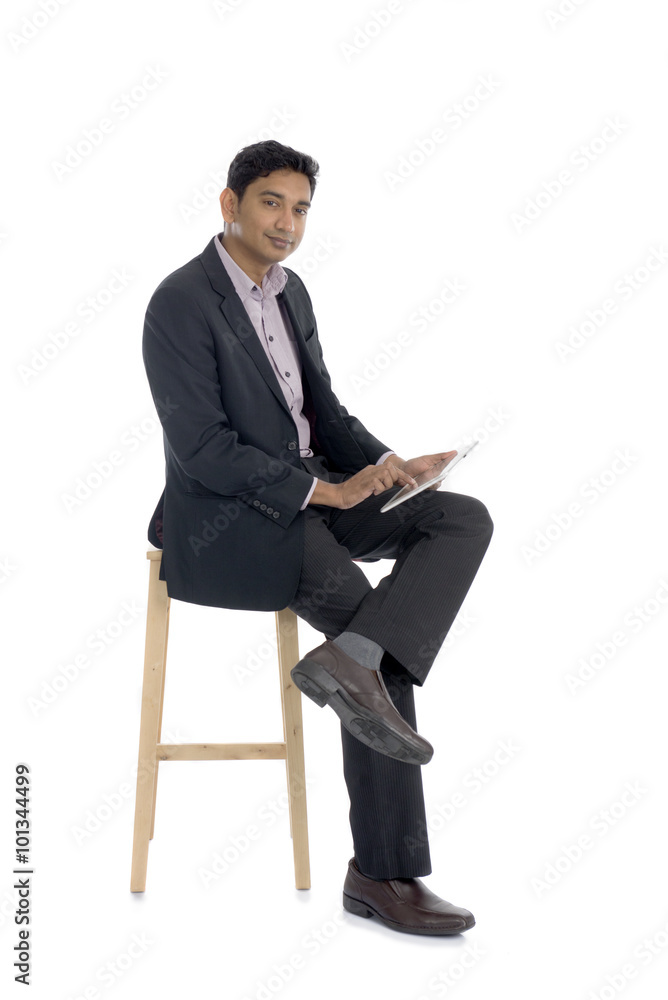 dark complexion business man using tablet while sitting dark complexion business man using tablet while sitting
