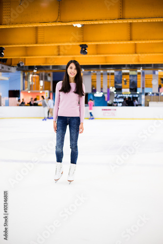 Asian woman ice skating indoor ice rink