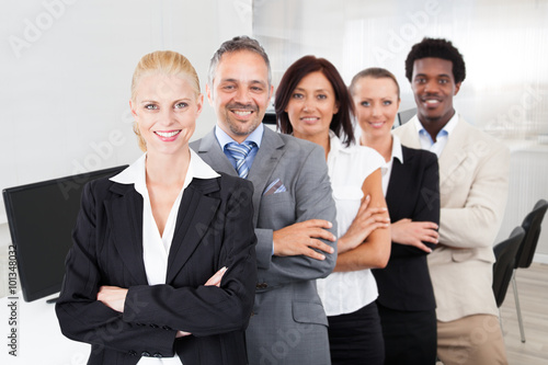 Multiethnic Team With Arms Crossed Smiling In Office