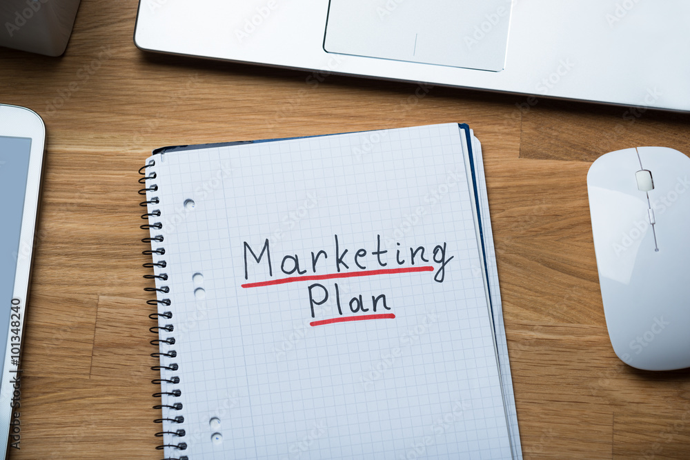Marketing Plan Written On Notepad At Office Desk Marketing Plan Written On Notepad At Office Desk