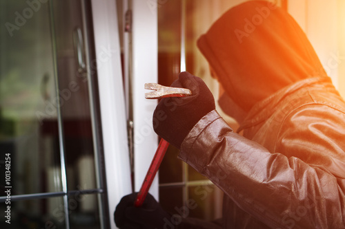 Burglar breaking in a house photo