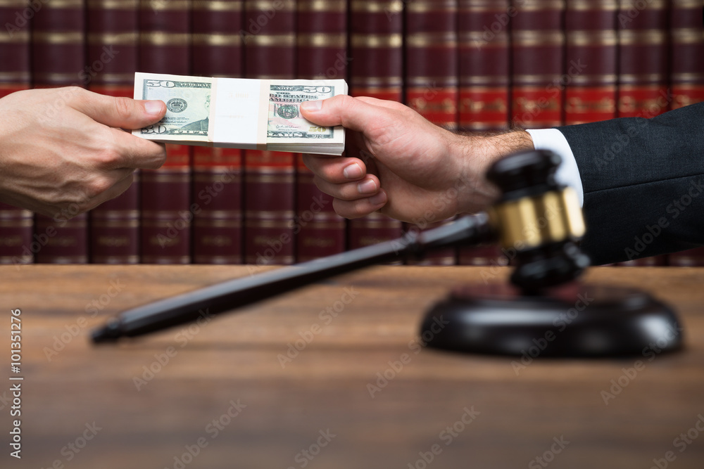 Gavel On Table With Judge Taking Bribe From Businessman Gavel On Table With Judge Taking Bribe From Businessman
