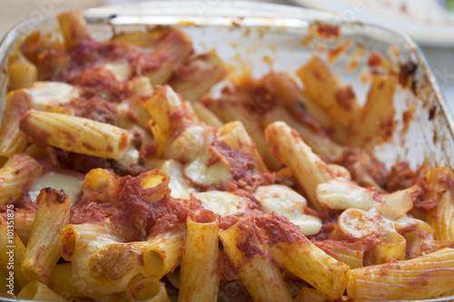 kaked rigatoni pasta with mozzarella and tomato sauce photo