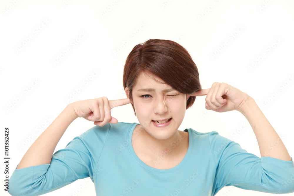 Young Japanese woman suffers from noise Young Japanese woman suffers from noise