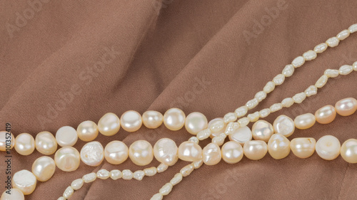 pearl beads on brown cloth