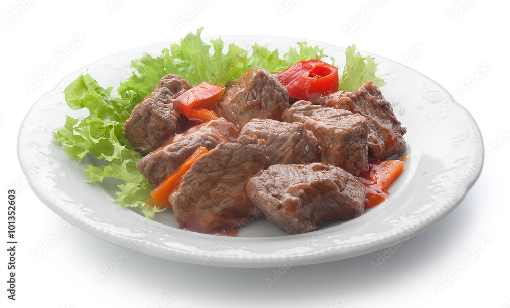 Beef goulash with lettuce on the plate
