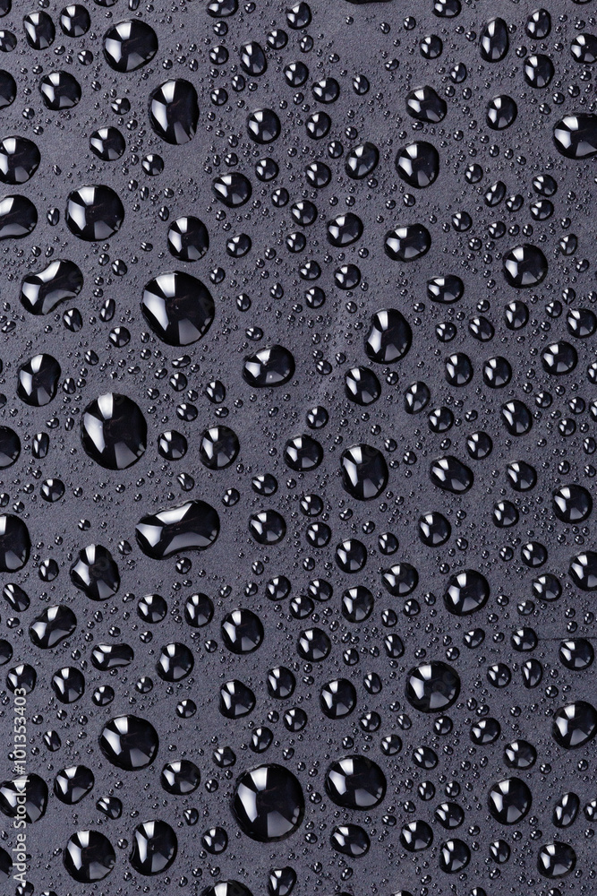 water drops on a black plastic surface water drops on a black plastic surface