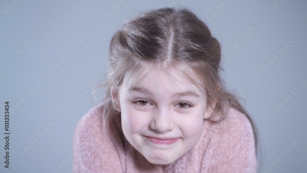 Smiling girl fashion portrait. Child model. Portrait of beautiful little girl making faces and having fun in studio. Smiling girl fashion portrait. Child model. Portrait of beautiful little girl making faces and having fun in studio.