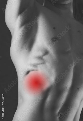 fragment of body of a young man with pain in chest or lungs. monochrome picture with red as a symbol of the pain