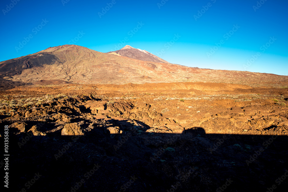 Volcanic landscape with car shadow