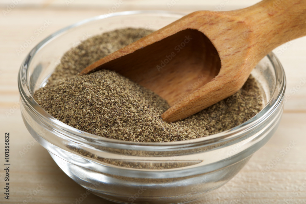black pepper powder on wooden background black pepper powder on wooden background