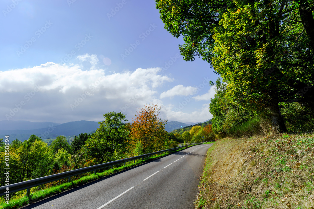Winding asphalt road in countryside region of France