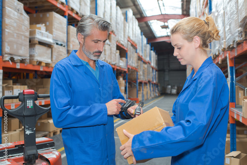 Man scanning parcel with handheld machine