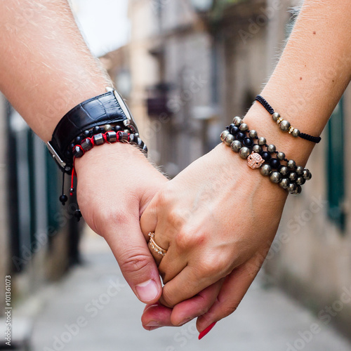 Couple holding hands with bracelets