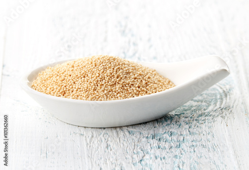 Картината върху платно Amaranth seeds in porcelain spoon