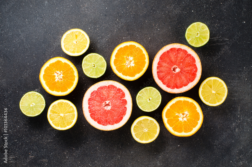 Mix of citrus fruits on dark table Mix of citrus fruits on dark table