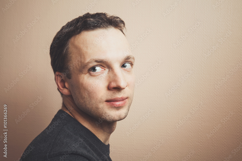 Young Caucasian man studio portrait over gray wall Young Caucasian man studio portrait over gray wall