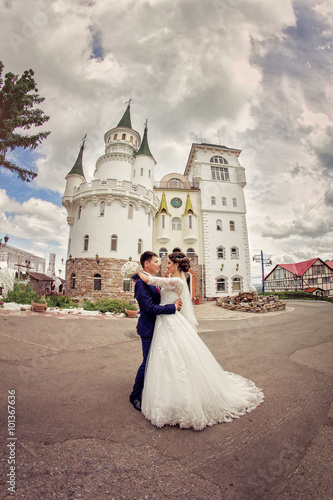 Elegant bride and groom hugging on the background of the modern