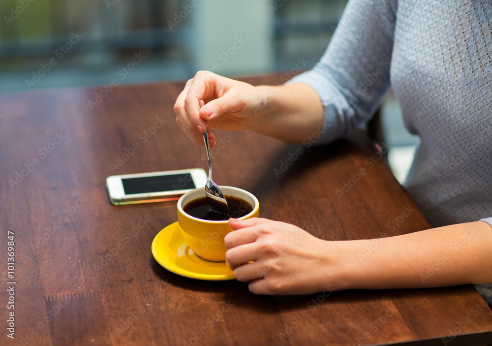 close up of woman with smartphone and coffee