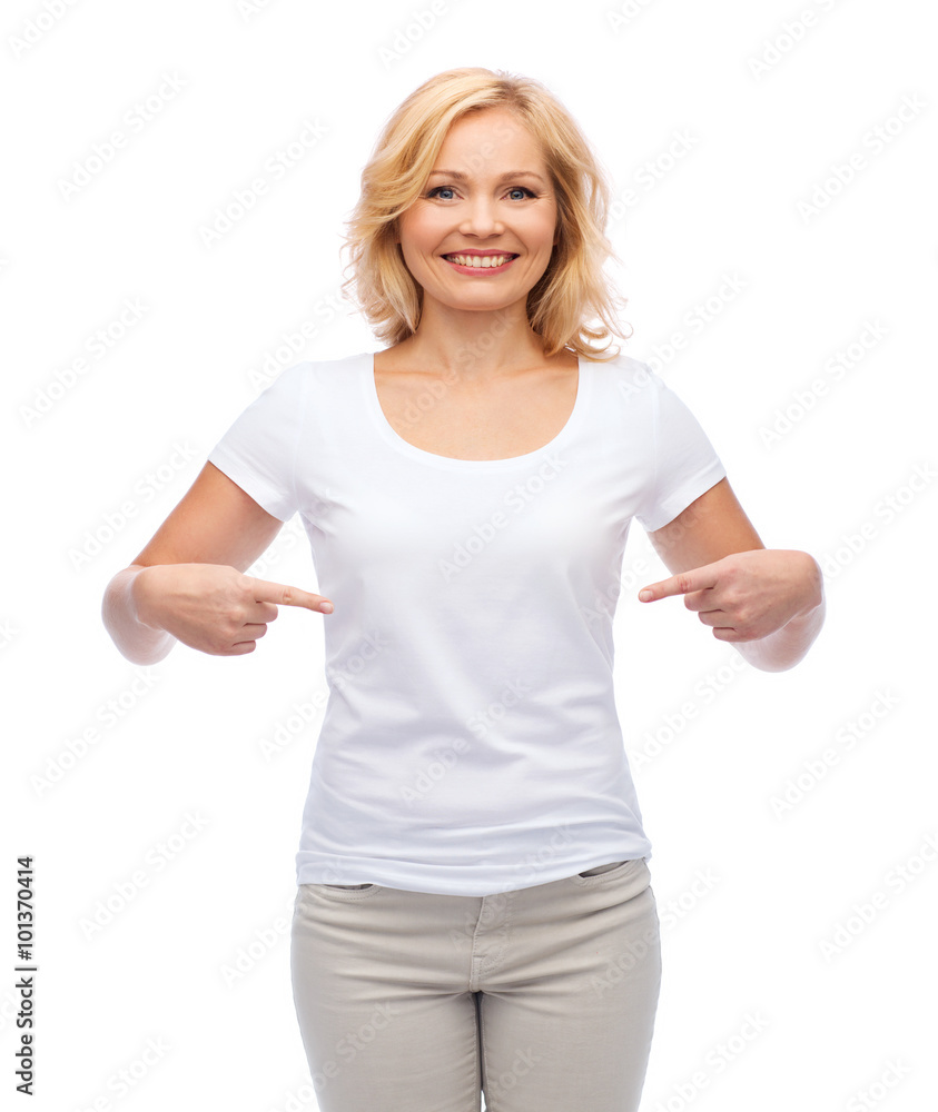 Fototapeta premium smiling woman in white t-shirt pointing to herself