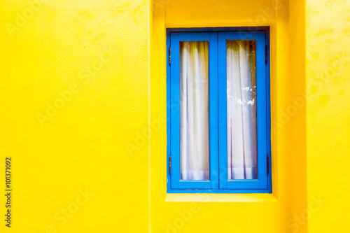 Blue window on yellow wall