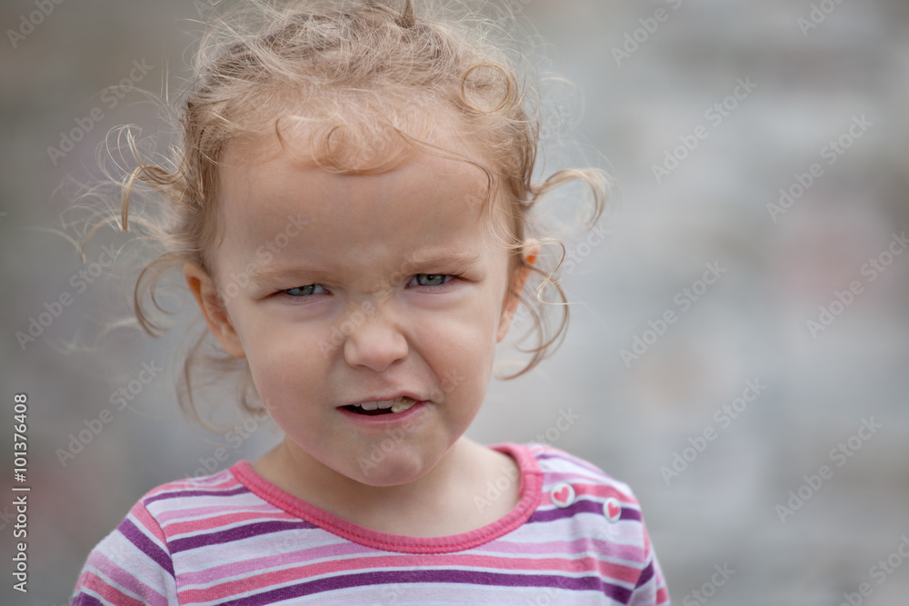 Beautiful little girl making funny faces