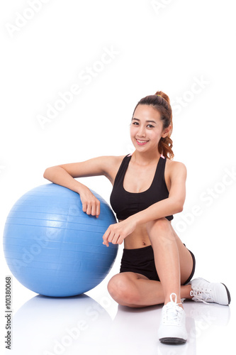 Full length sport young woman doing exercises with fitness ball. © japhoto